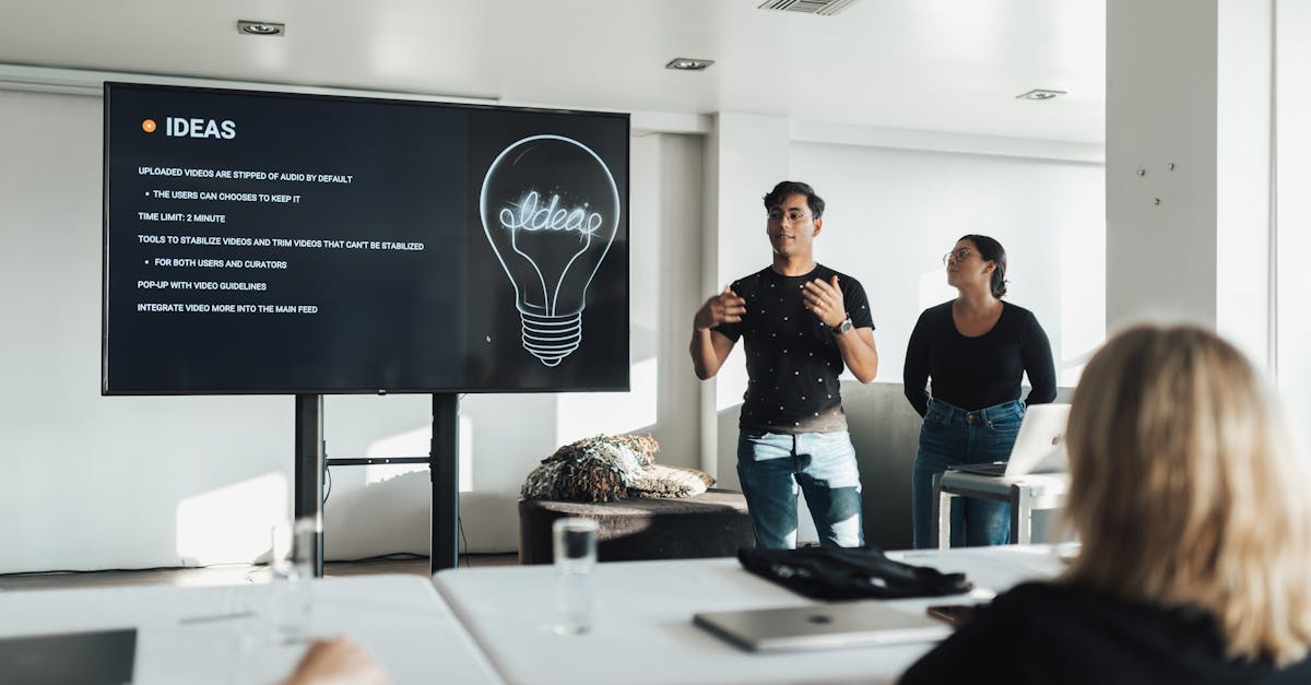 Two colleagues giving a dynamic business presentation in a modern office environment, engaging their audience.