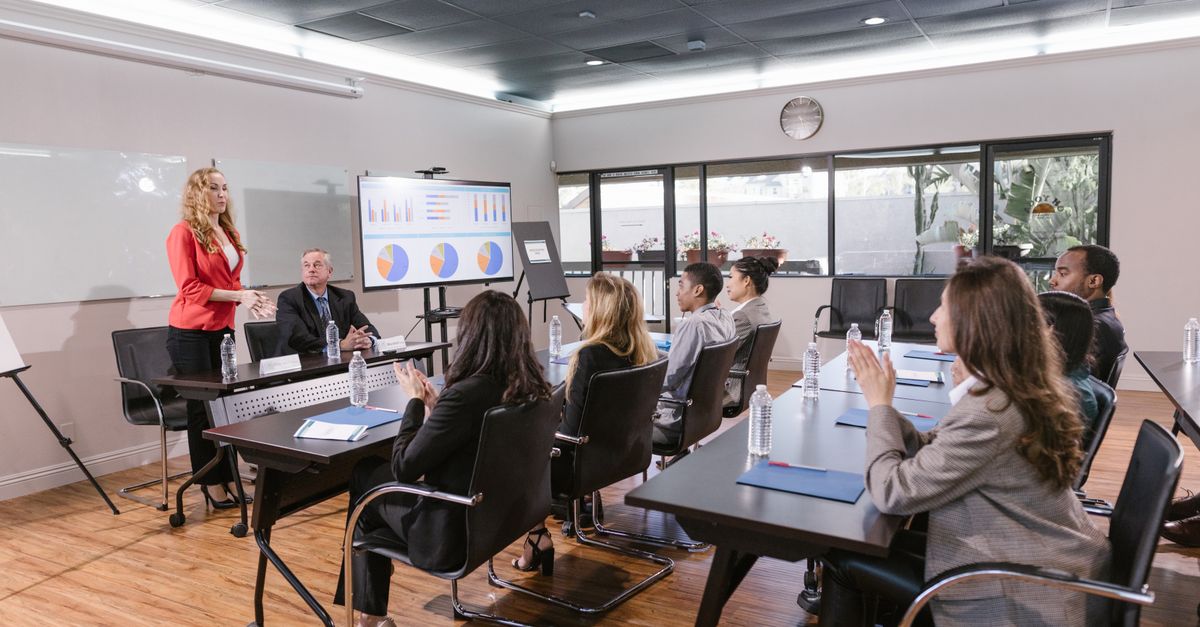 Business professionals attending a meeting in a modern conference room.