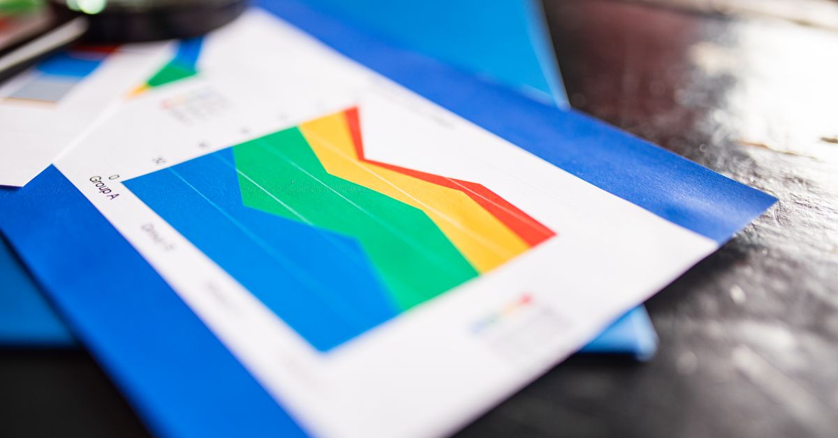 Close-up of a colorful business chart placed on a table with documents highlighting trends.