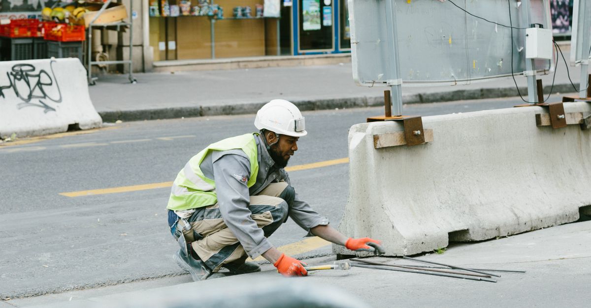A construction worker operates on a city street in Paris, France, showcasing urban development.