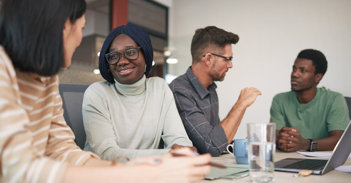 A diverse group of coworkers engaged in a collaborative office meeting, fostering teamwork and innovation.