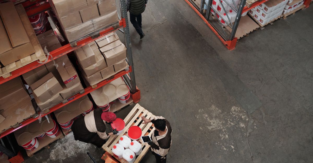 High angle view of warehouse workers handling inventory and logistics operations.