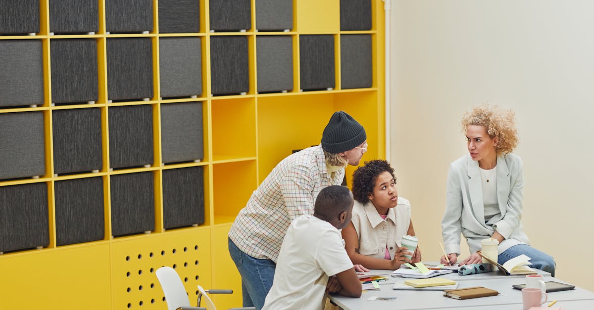 Colleagues engaged in a collaborative meeting in a modern, colorful office space.