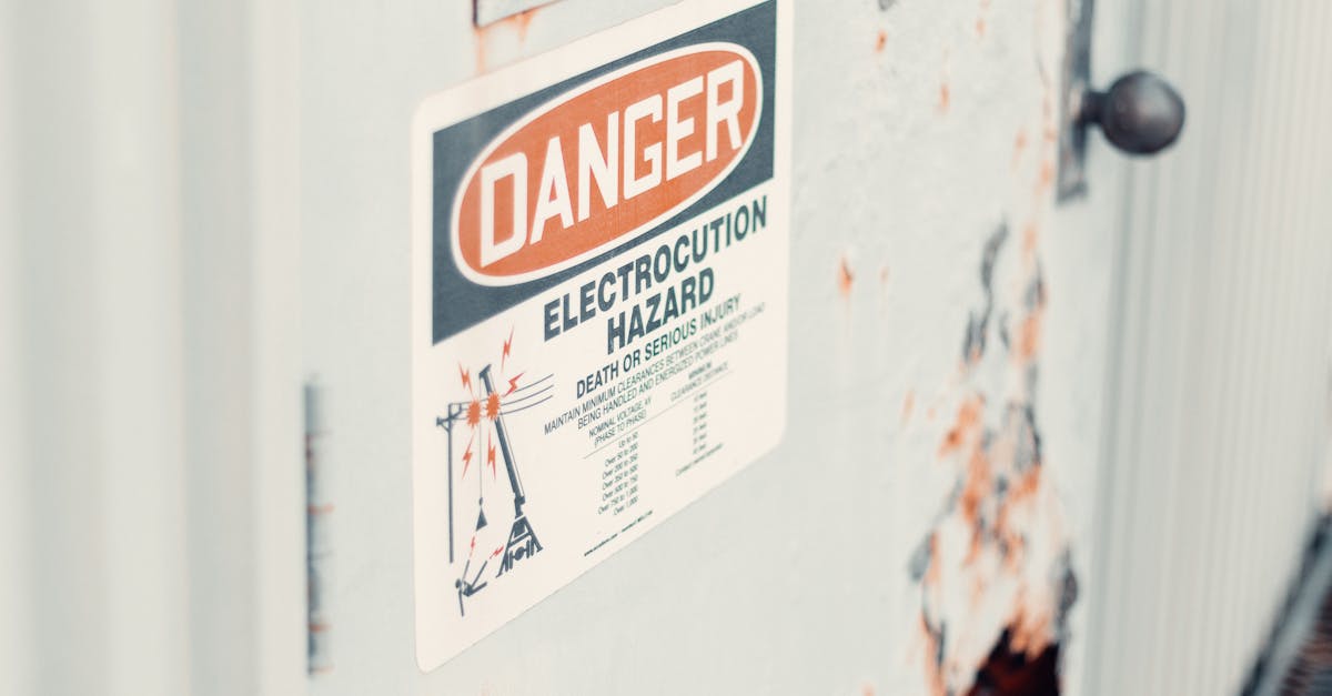 Close-up of a danger sign warning of electrocution hazard on a rusty utility door, indicating safety precautions.