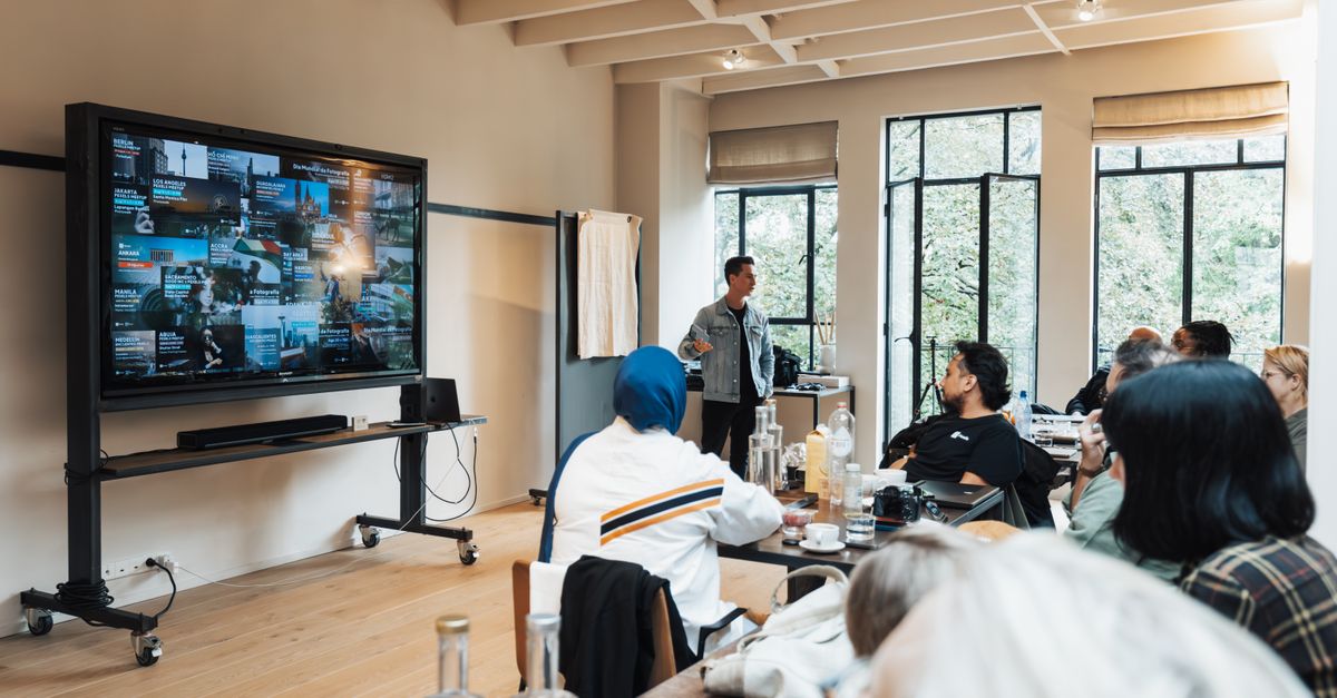 Corporate team engaged in a presentation in a modern office setting.