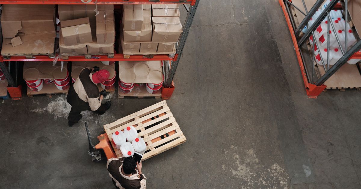 High angle view of workers organizing inventory in a warehouse.