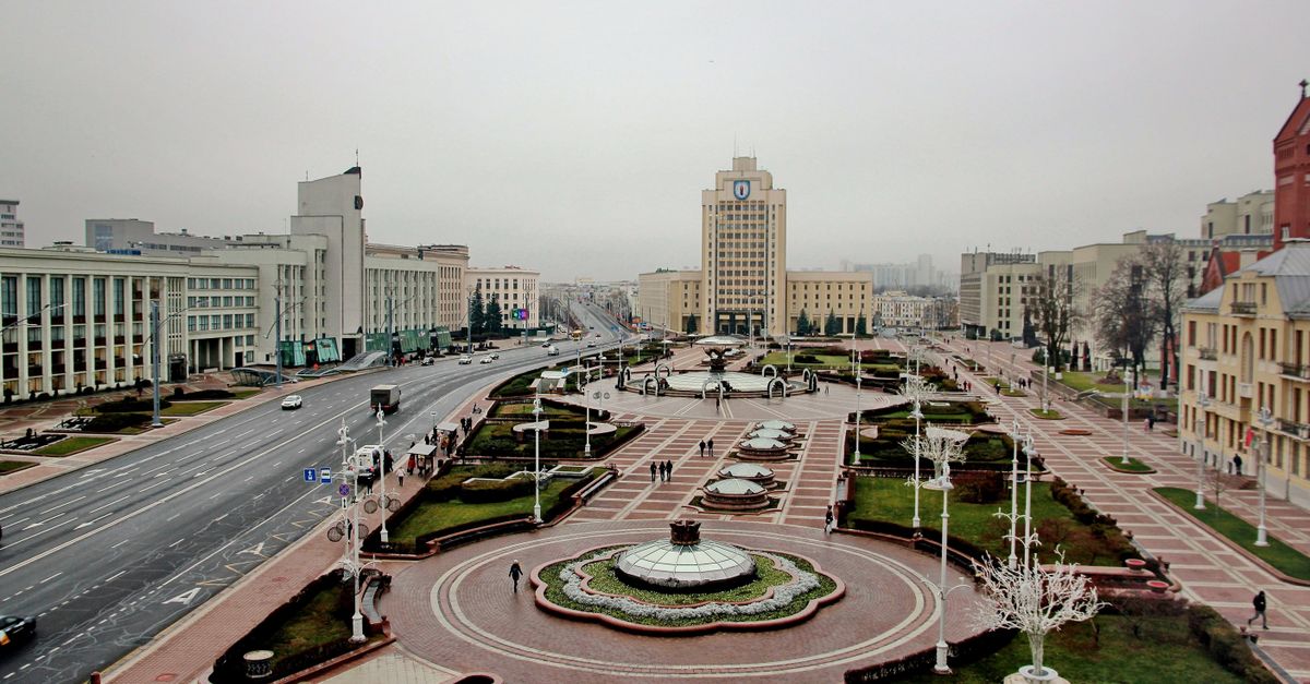 Foggy view of Minsk city center plaza with architectural buildings and open space.