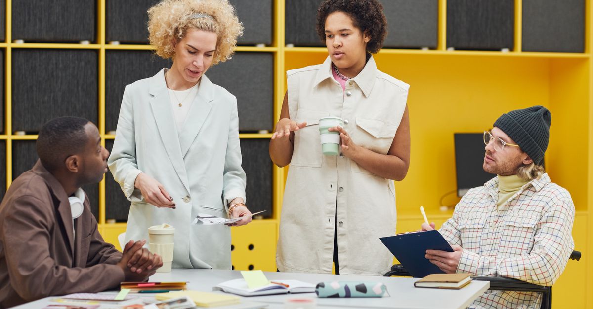 A diverse group of coworkers engaged in a brainstorming session in a modern office.
