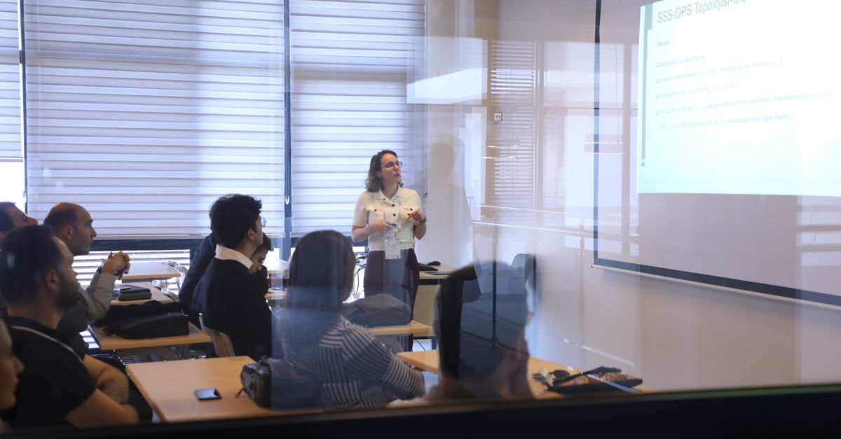 Audience attending a business presentation in a modern office environment.