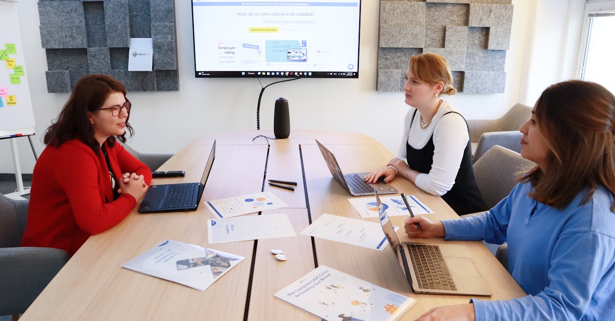 Women discussing business strategy in a modern office during a team meeting.