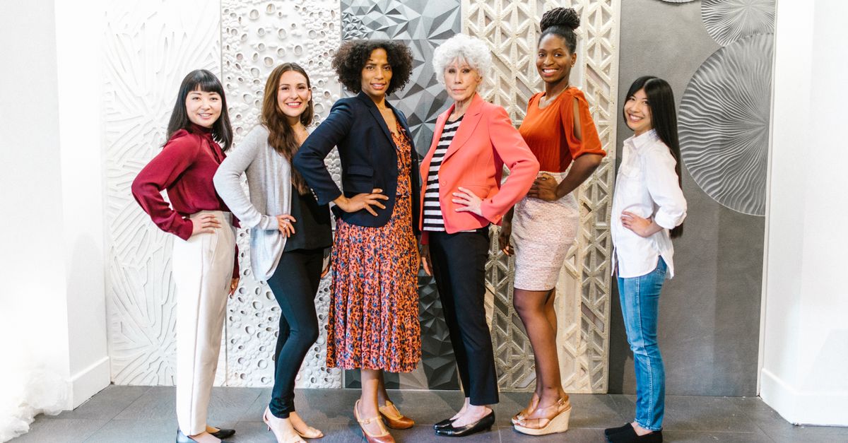 Group of confident women leaders posing in a stylish, modern office environment, showcasing empowerment and diversity.